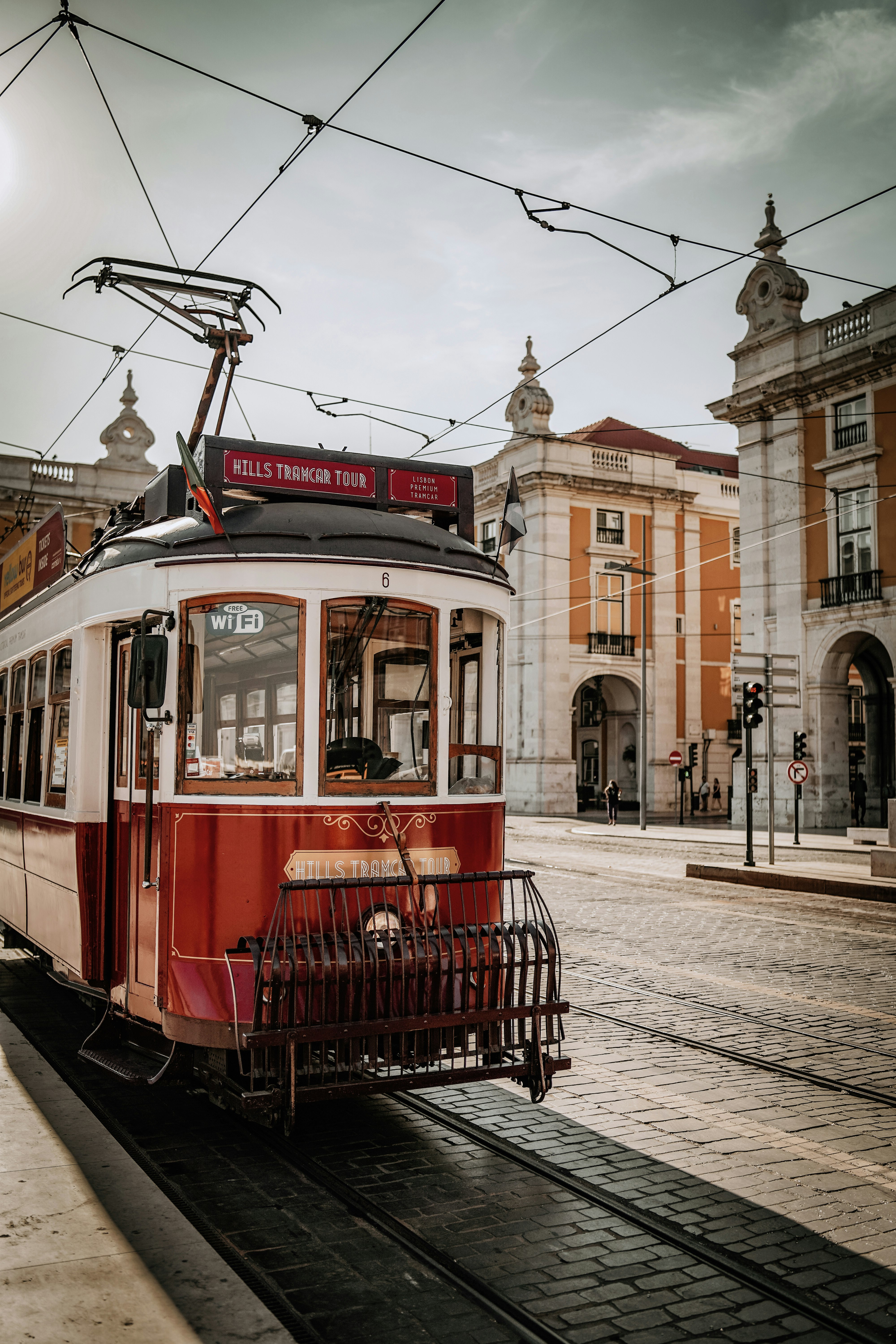 red and white tram on road near building during daytime